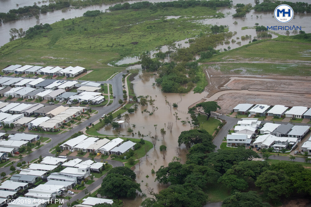 Ross River overruns banks into Idalia streets, aerial photograph during floods, Idalia, 2019