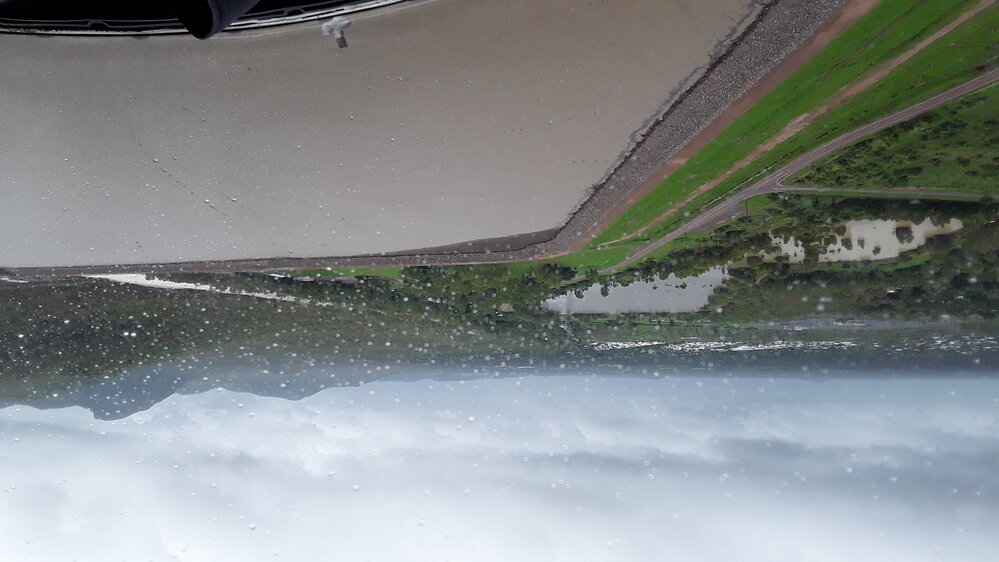 Ross River Dam Wall beside Riverway Drive, aerial photograph during floods, 2019. 