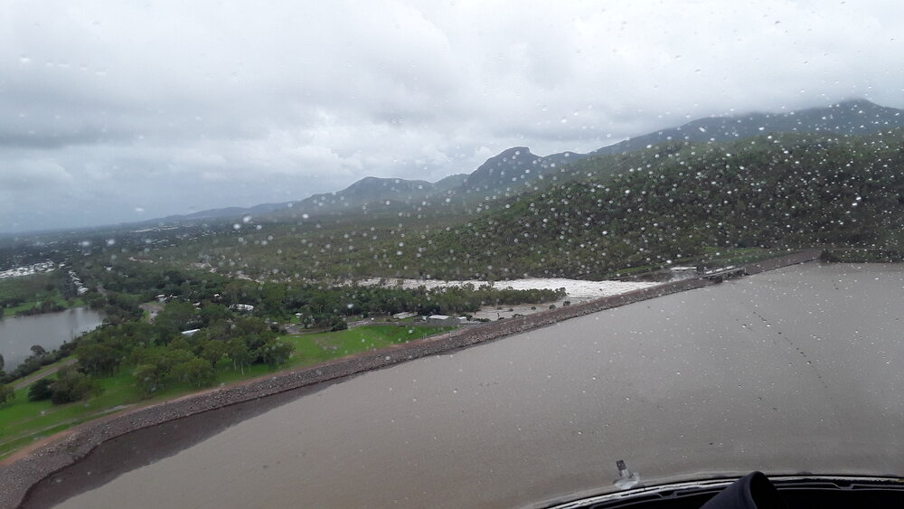 Ross River Dam Wall beside Riverway Drive, aerial photograph during floods, 2019. 