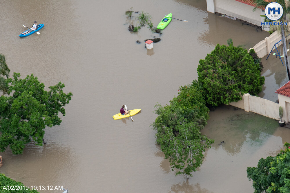 Inundated streets, people on kayaks, aerial photograph during floods, 2019. 