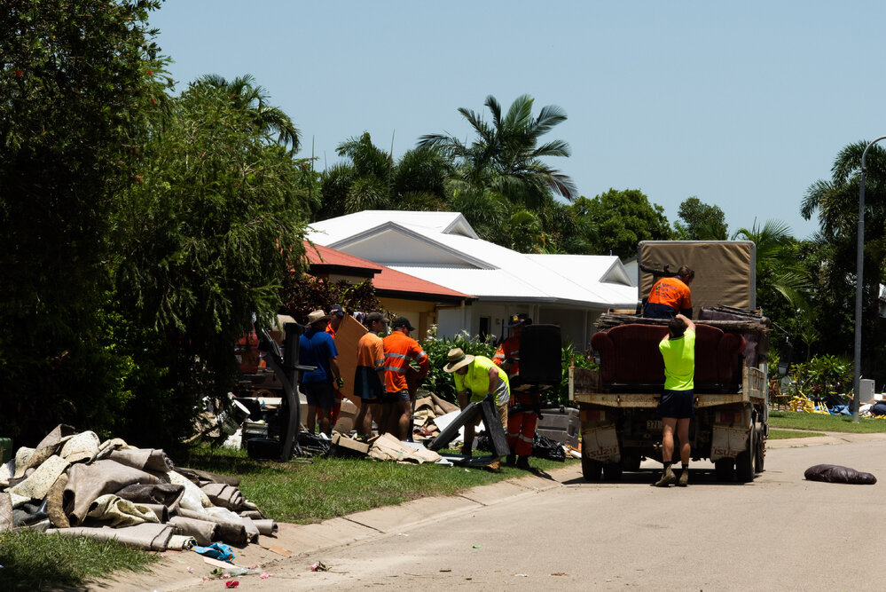 Resident volunteers load flood ruined furniture into a truck, 2019.