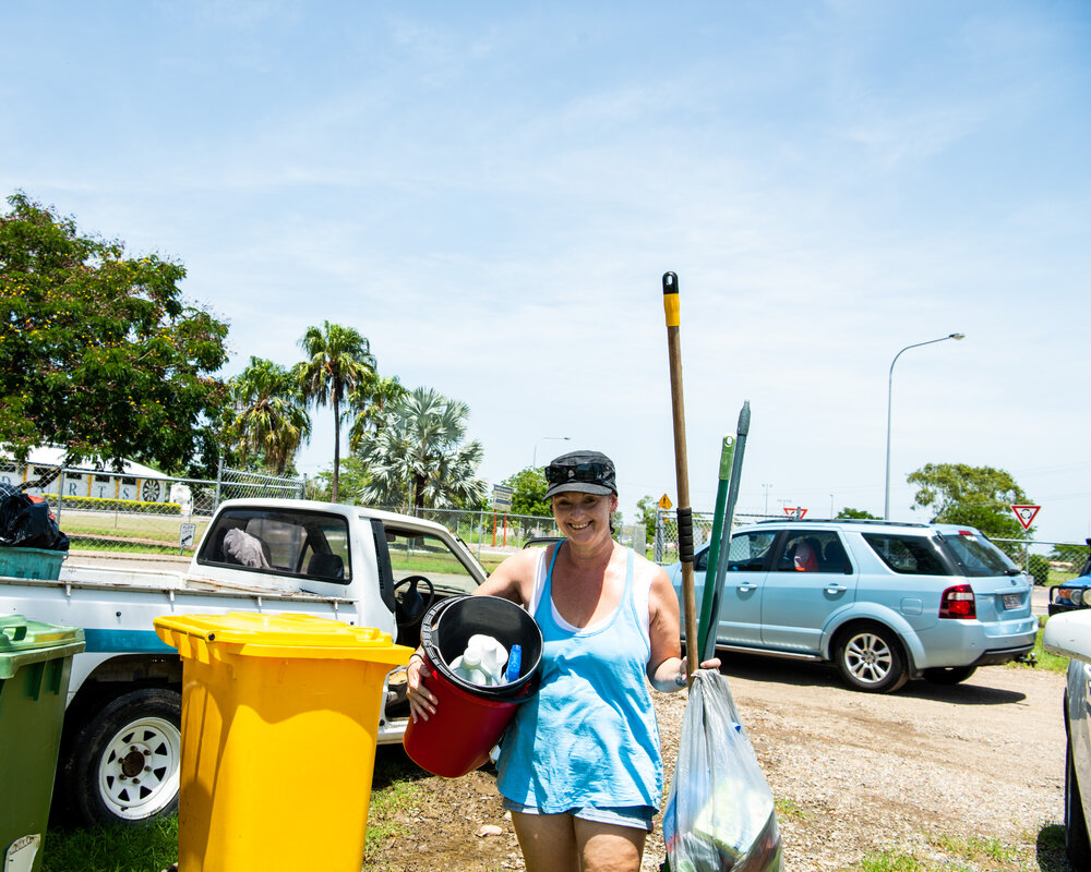 Hermit Park AFL Club volunteer carrying cleaning supplies, Hermit Park, 2019