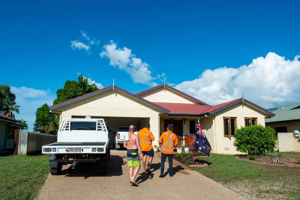 Residents/Volunteers standing in front of flood affected home, Idalia,  2019