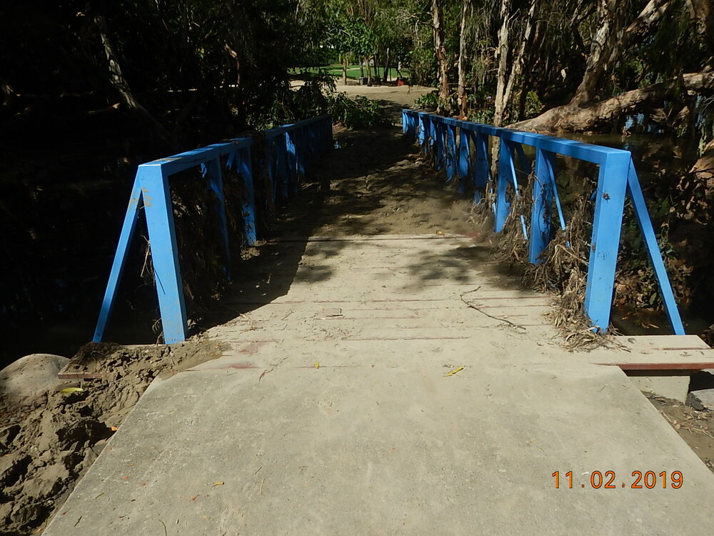 Debris and silt covered footbridge at the Riverside Gardens Community Centre, 2019. 