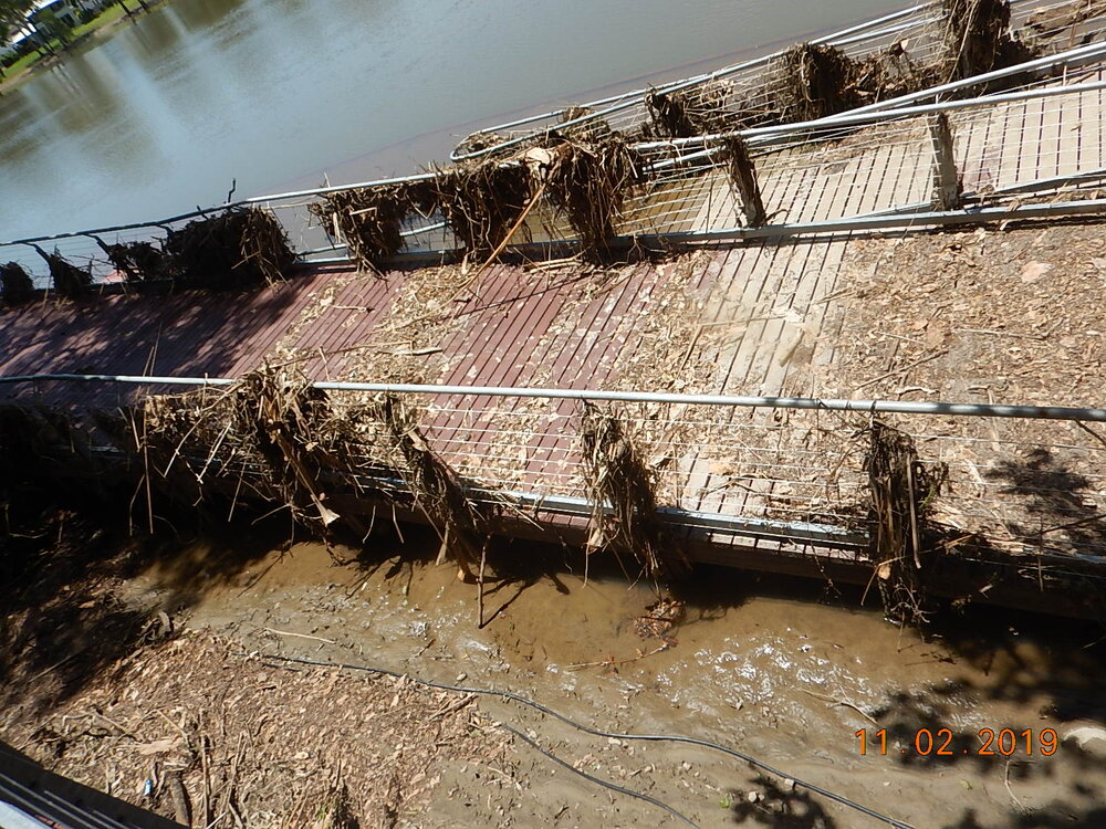 Submerged and debris covered Riverway boardwalk, 2019. 