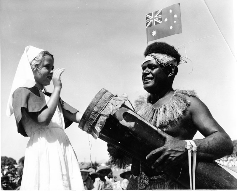 Willie Thaiday with a member of the Giru Junior Red Cross at the civic reception for Queen Elizabeth II and Prince Philip at the Sports Reserve, Townsville, March 1954. 