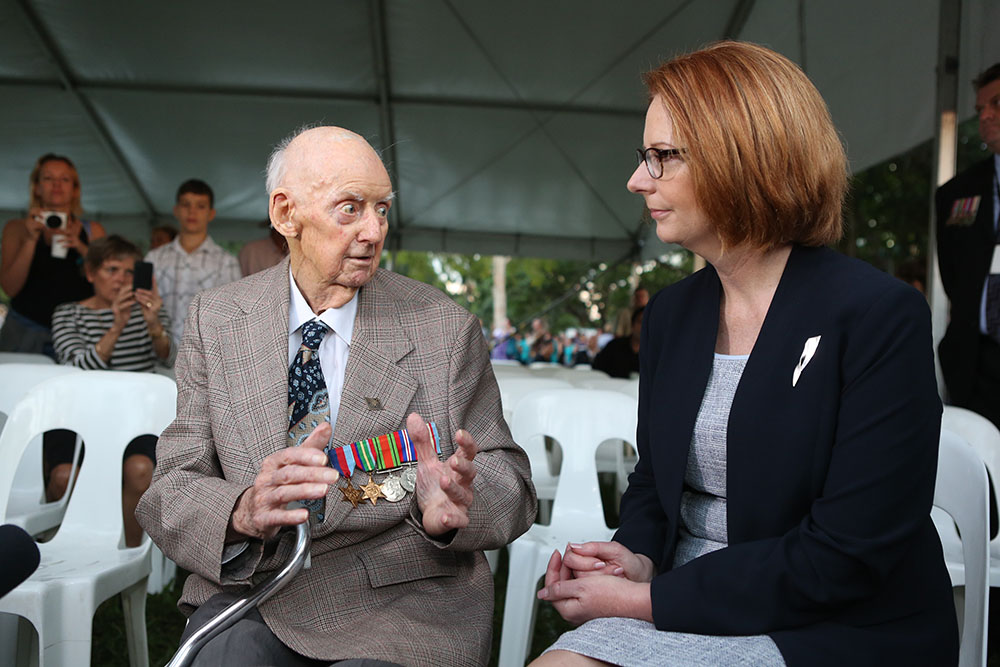 Prime Minister Julia Gillard talks to World War Two veteran Sidney King at the ANZAC Day commemoration at the Cenotaph, the Strand, Townsville, 25 April 2013