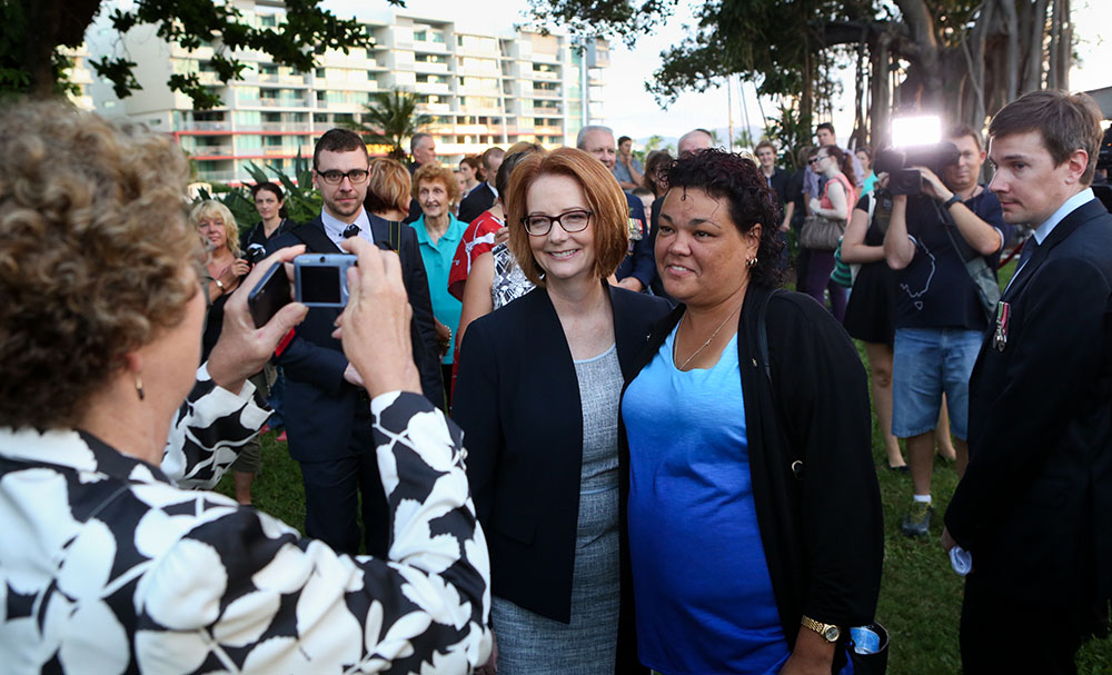 Prime Minister Julia Gillard posing for photographs at the ANZAC Day commemoration at the Cenotaph, the Strand, Townsville, 25 April 2013
