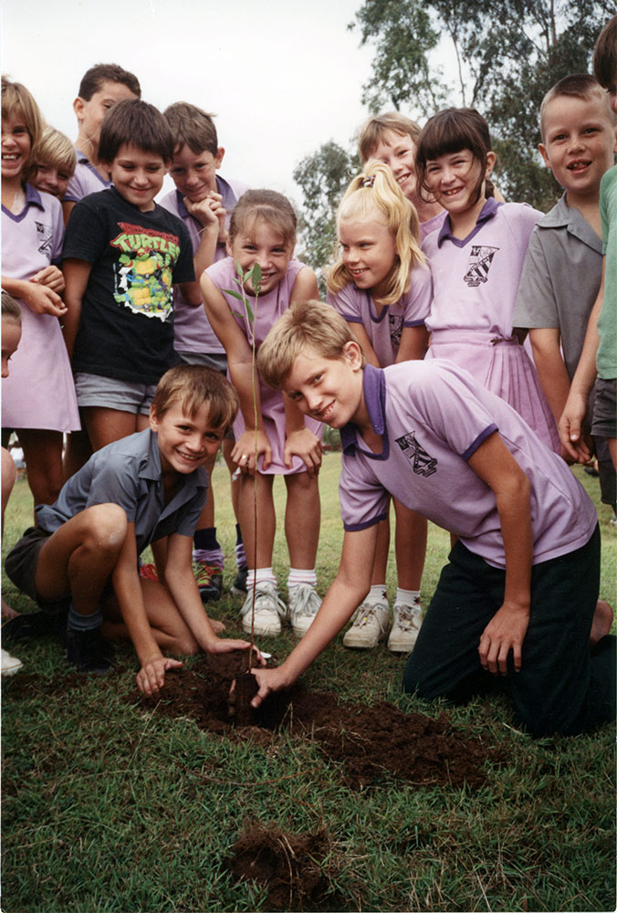 Children planting a tree, Townsville, 1991