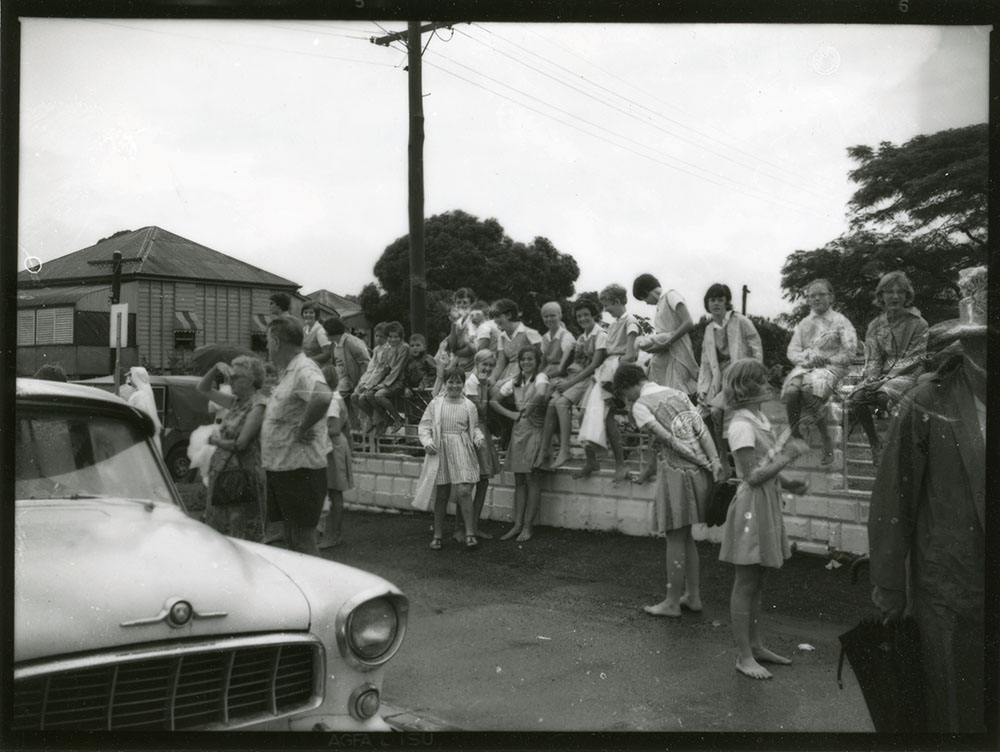 Students of St. Margaret Mary's School watch traffic on flooded Charters Towers Road, Hermit Park, Townsville, 15 February 1968