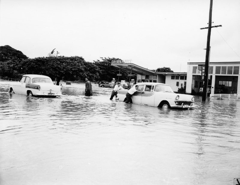 Flooding on Charters Towers Road, near Golden Fleece service station, Townsville, 1965