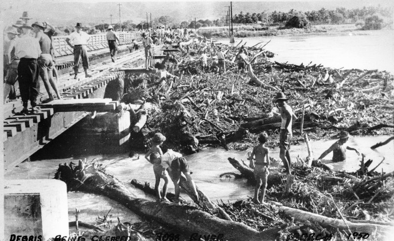 Debris being cleared from Rooney's bridge, Ross River, Townsville, after the 1950 flood. 