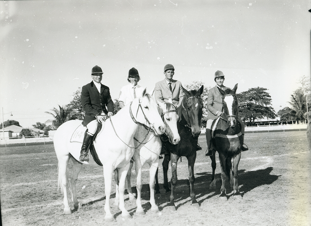 Four equestrians and horses in the centre ring of the Townsville Show, 6 July 1966