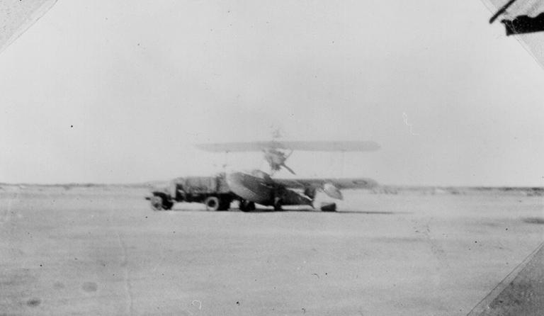 Walrus aircraft in airfield with truck, ca 1940 