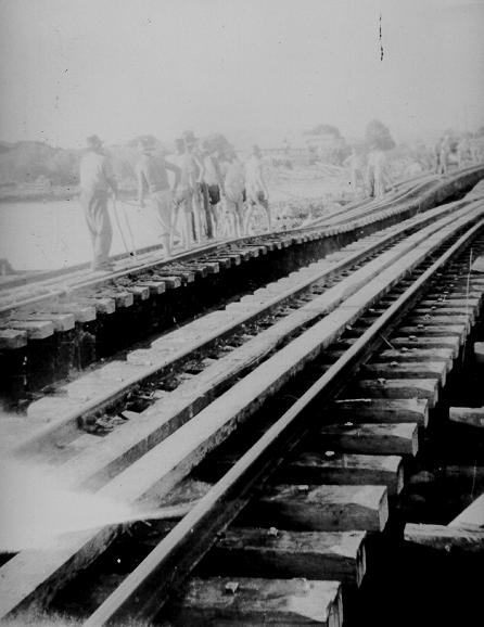 Men fixing Rooney's Bridge during floods, Railway Estate, 1946 