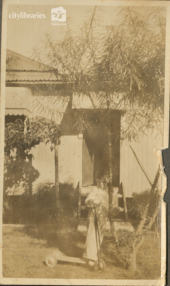 Pat O'Brien on scooter, Camp Street, Mundingburra, ca. 1935