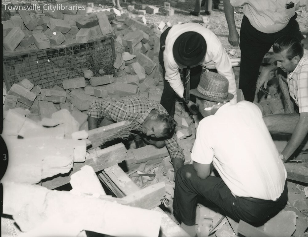 Inspecting bomb damage to Brothers Clubhouse, Gill Park, Townsville, 10 May, 1969