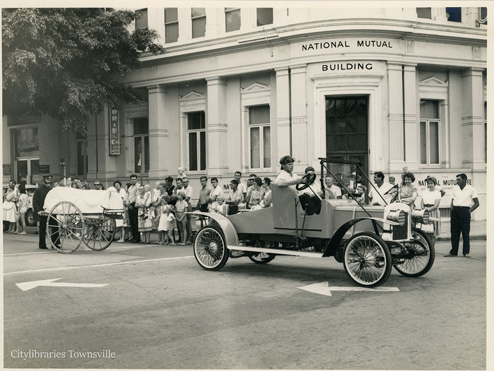 Vintage car and first ambulance entries in the Centenary Parade, corner of Flinders and Denham Street, Townsville, 7 November 1964