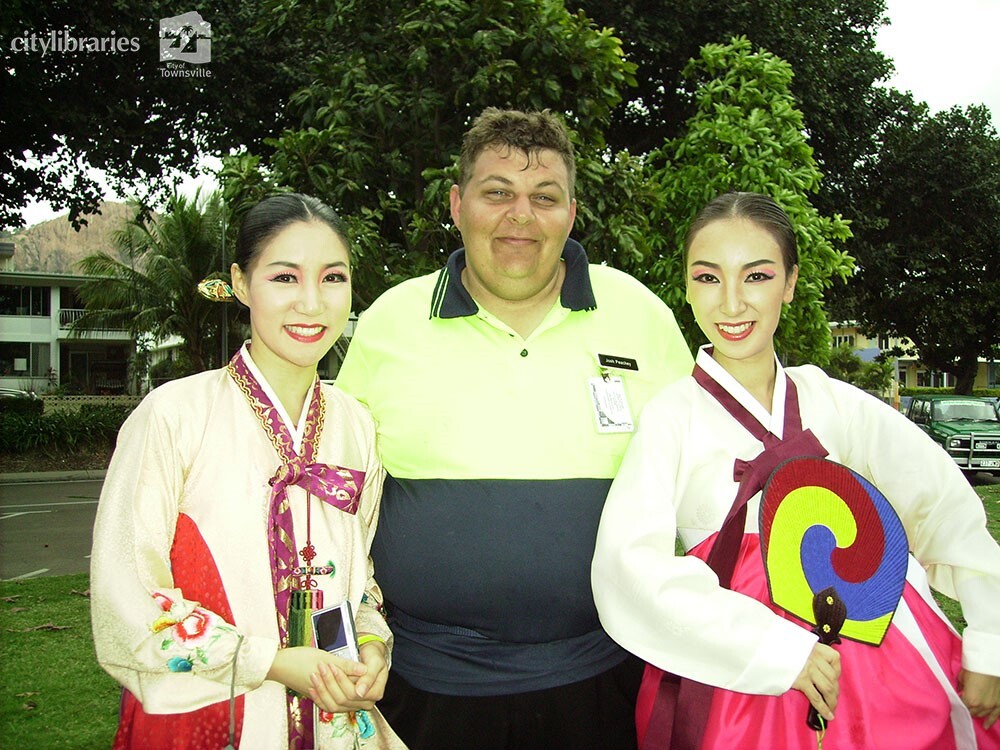 Performers from Suwon City Korea, posing with a volunteer after the Tropigo Carnival parade at Cultural Fest, The Strand, Townsville, 18 August 2007