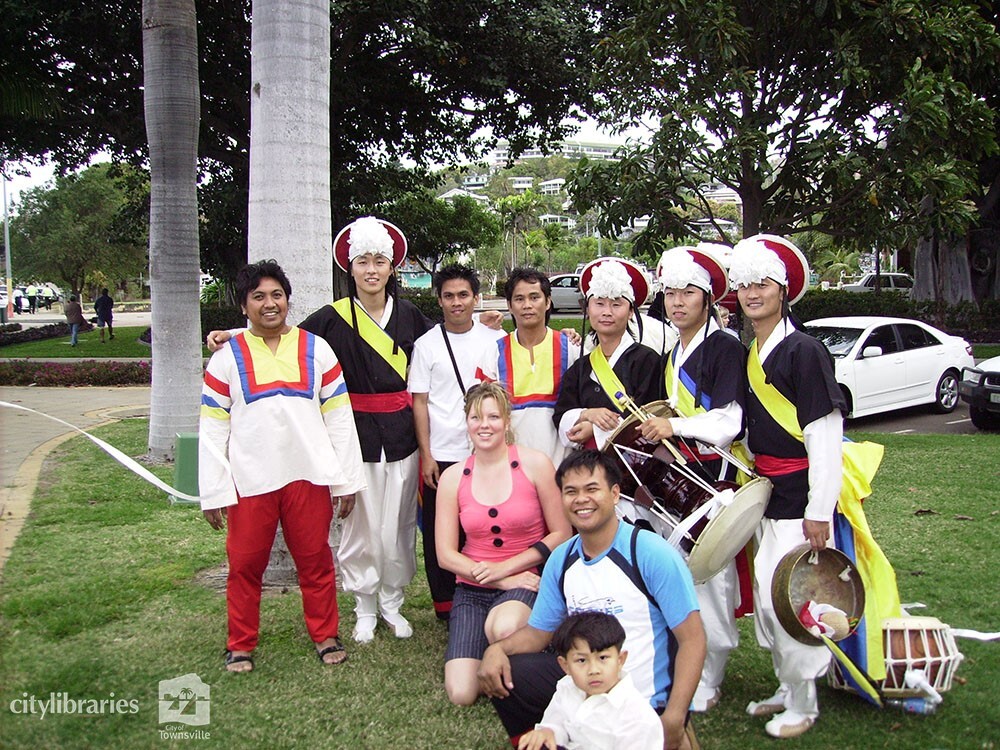 Performers from Suwon City Korea, with members of the public after the Tropigo Carnival parade at Cultural Fest, The Strand, Townsville, 18 August 2007