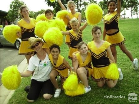 Performing group posing with staff member after the Tropigo Carnival parade at Cultural Fest, The Strand, Townsville, 18 August 2007