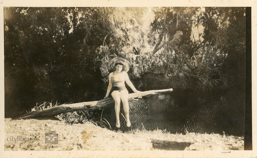 Person posing next to a creek, 1948