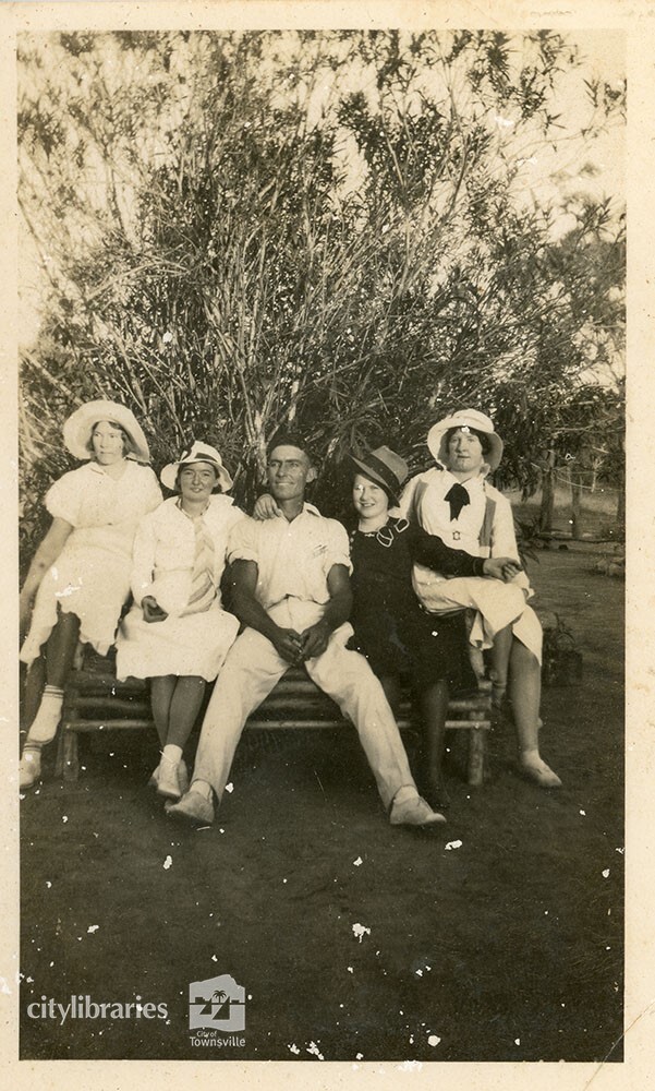 Group posing on a picnic bench, 1934