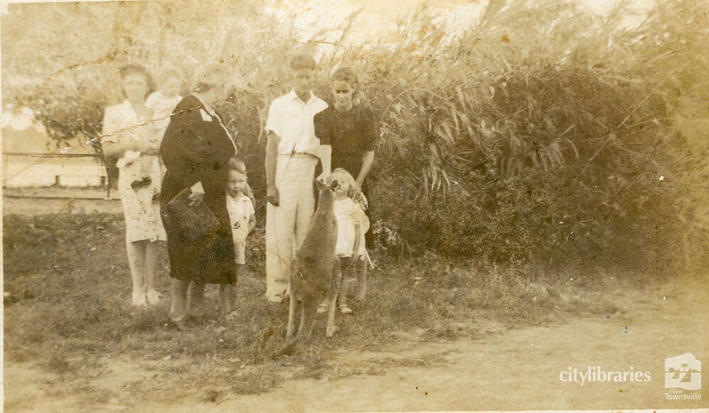 Group posing with a kangaroo, 1948