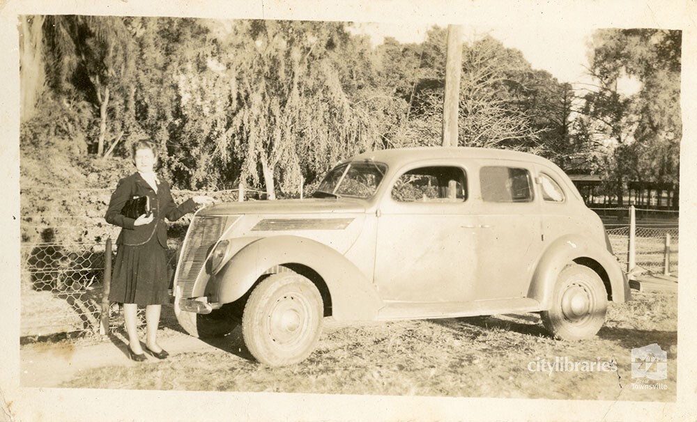 Person posing with a car, August 1944