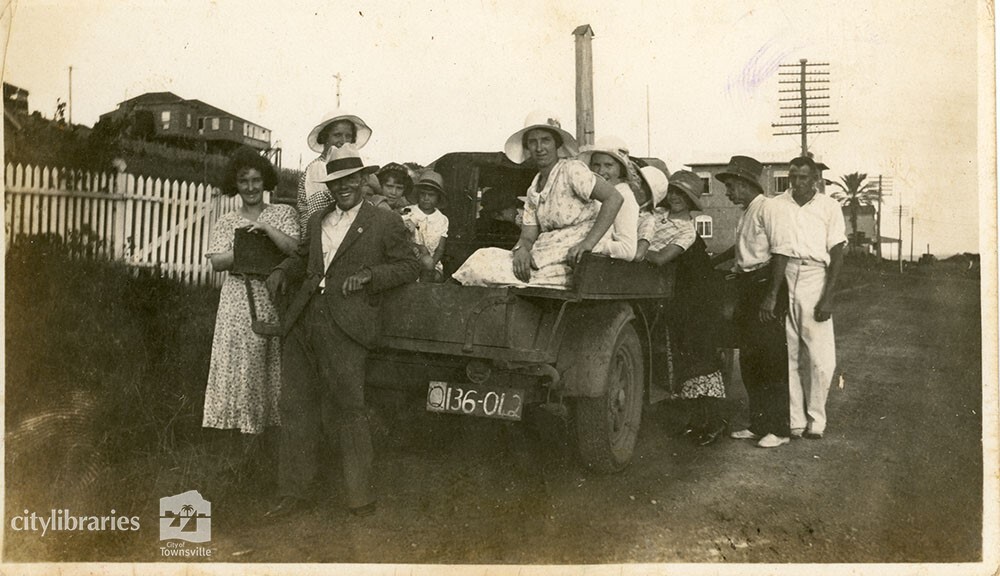 Group sitting in the back of a tractor, 1934