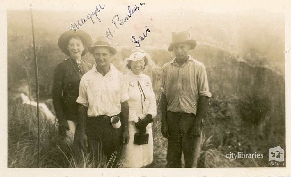 Group posing with a scenic background, ca. 1940