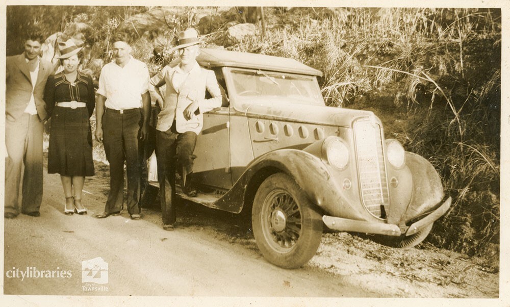 Group posing with a car, August 1939