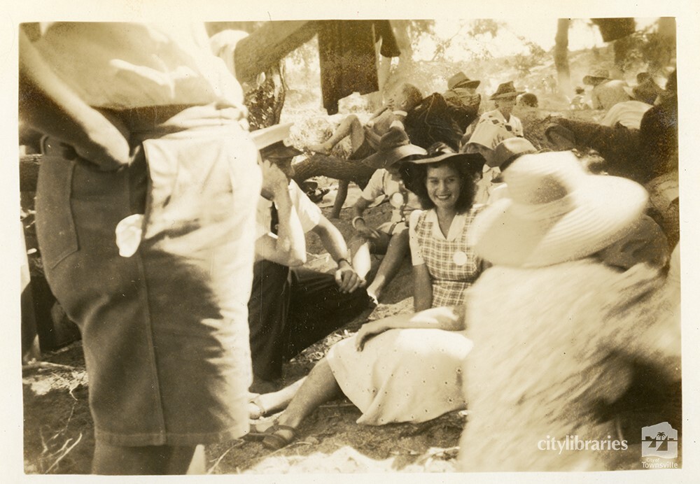 Woman posing for a photograph, amongst a group, Townsville, ca. 1946