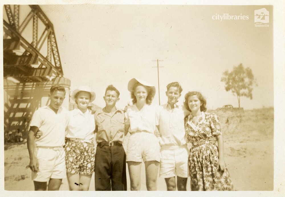Group posing for a photograph under a bridge, Townsville, ca. 1946
