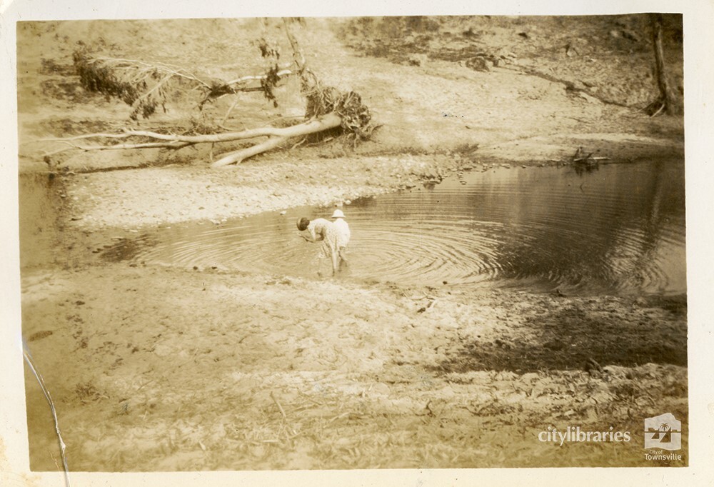 Mrs Dawson and son in the water at the C.O.D. picnic, Alice River, Townsville, 1946