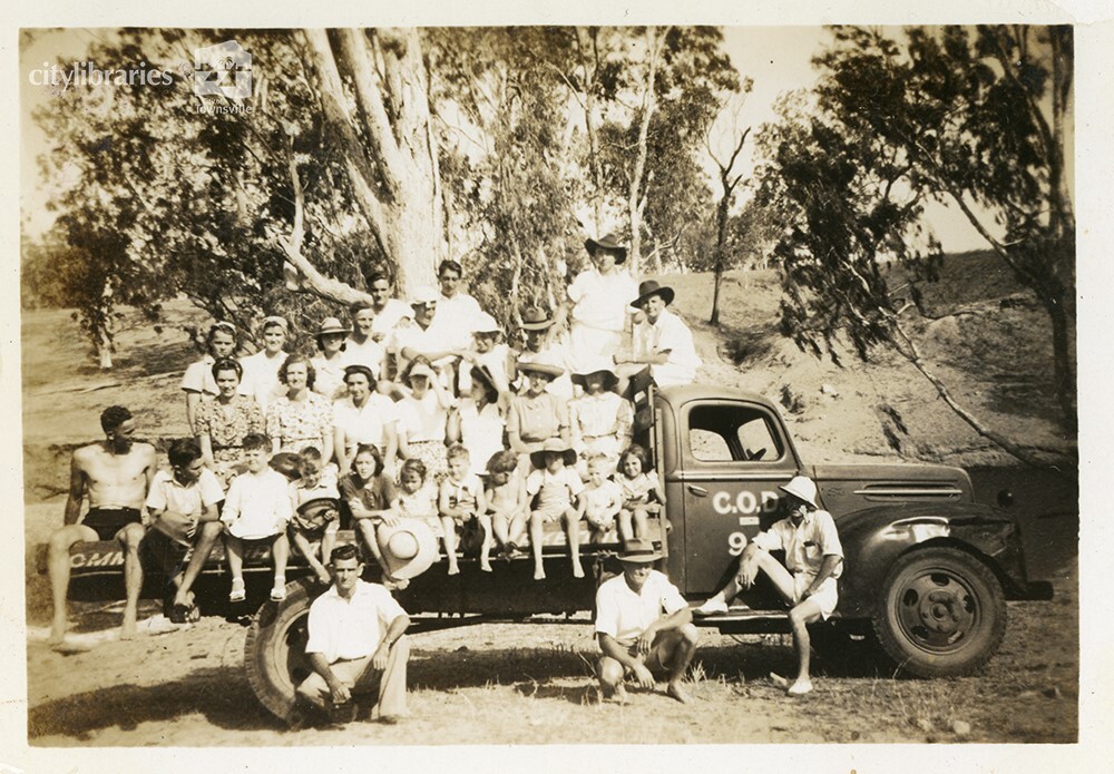 Group posing on the back of a truck, C.O.D. picnic,  Alice River, Townsville, 1946