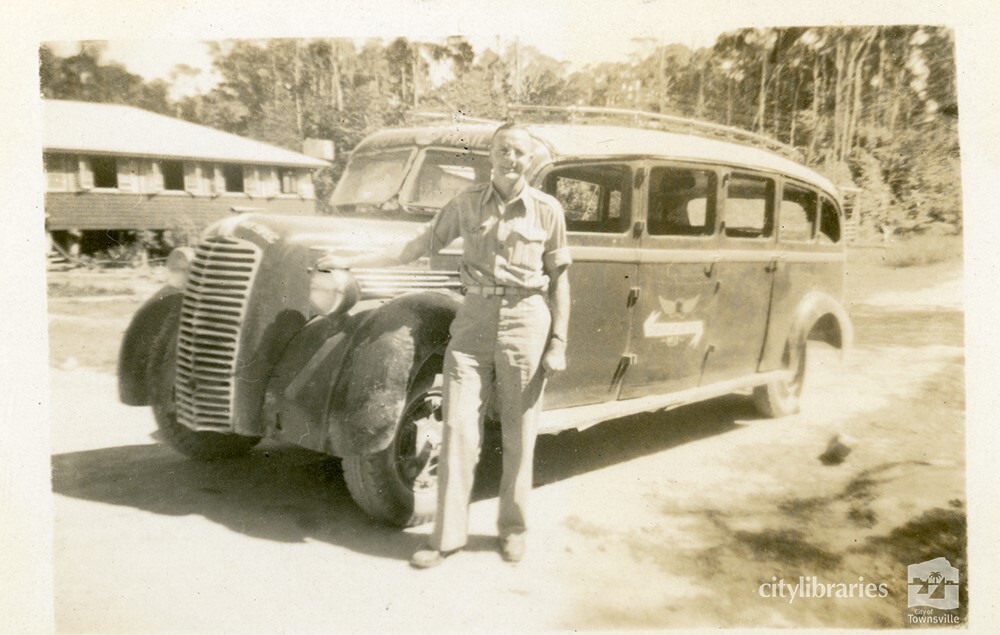 Reg Simmons posing in front of a vehicle, Townsville, ca. 1946