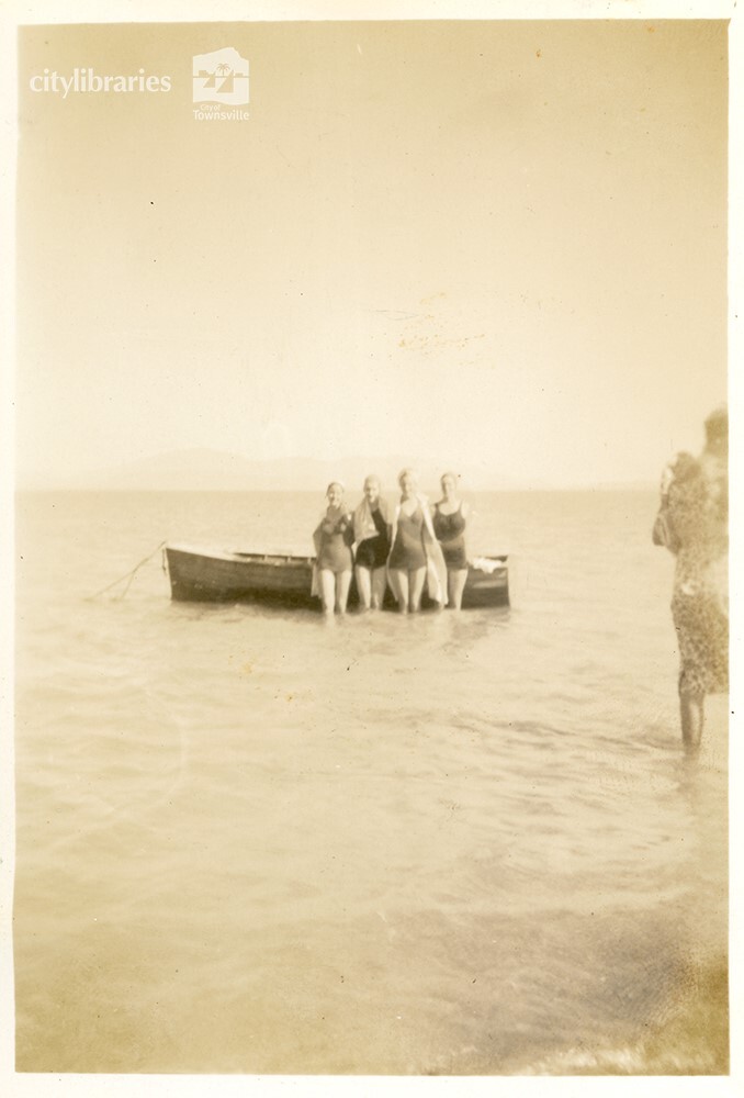 Group posing in front of a boat, [Magnetic Island], Townsville, ca. 1949