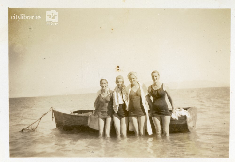 Group posing in front of a boat, [Magnetic Island], Townsville, ca. 1949