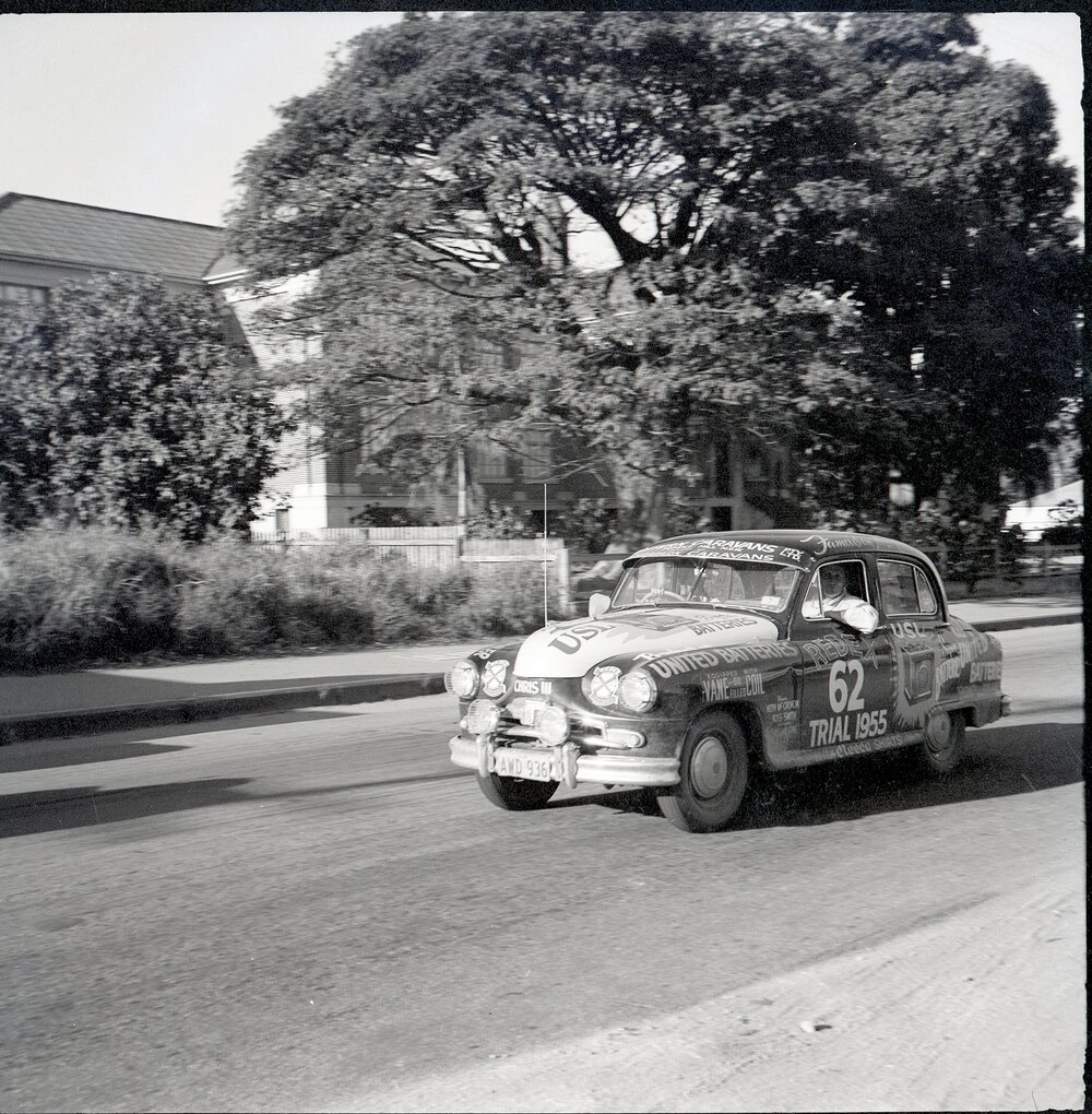 Car 62 in the Redex Trial 1955 on Ingham Road, Townsville. West End Primary School in the background