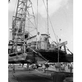 William Willis on his raft "Age Unlimited" being lifted aboard the ANL Boonaroo, Townsville, 6 November 1964