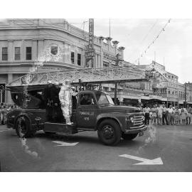 Fire engine in the Centenary Parade, corner of Flinders and Denham Street, Townsville, 7 November 1964