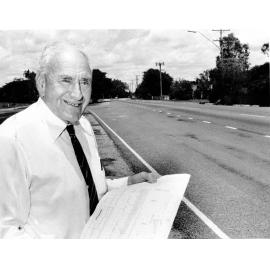 Mayor of Thuringowa, Mr Dan Gleeson, looks over plans to widen Upper Ross River Road from two to four lanes. 