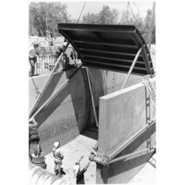 Woolcock Street canal, tide gates being lowered into position, Townsville, 1971