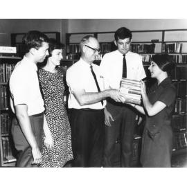 [Members of the Church of Jesus Christ of Latter Day Saints present a set of seven books to the Townsville Library to commemorate Library Week, 1968] 