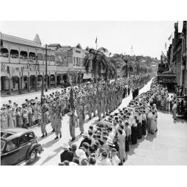 The Army and the R.S.L. Band marching in the Jubilee Day procession, Flinders Street, Townsville City, Townsville, 9 May 1951