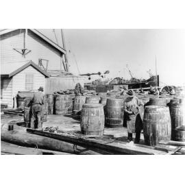Caulking tallow casks, Townsville wharf 