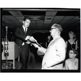 Reg O'Brien, manager of Woolworth's Big W store, presents Townsville Mayor, Alderman Harold Phillips with cheques for $300.00 each, for the Paraplegic and Associated Recreations and for the Foundation for Australian Literary Studies
