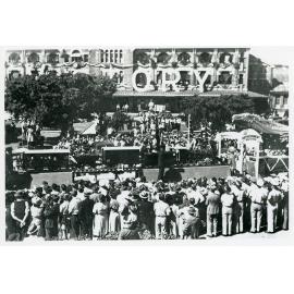 Victory Parade featuring the railway float passing by the Railway Station, Flinders Street West, Townsville, 10 June 1946