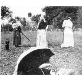 Australian South Sea Islander women with their children, hoeing weeds, ca.1900